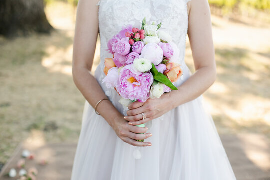 A Feminine Closeup Portrait of a Bride Holding a Bouquet 