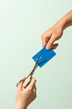 Cutting a Credit Card with Scissors Held by Two Hands