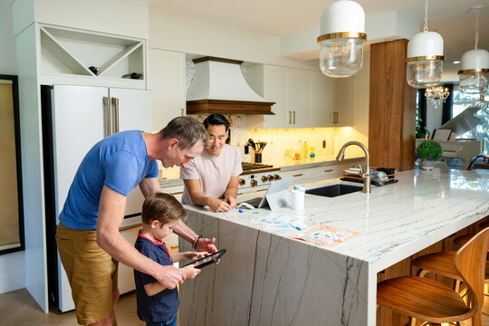 Dad Helps Son With Tablet