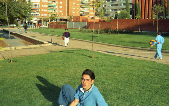 analog film image of a teenage boy in a city park