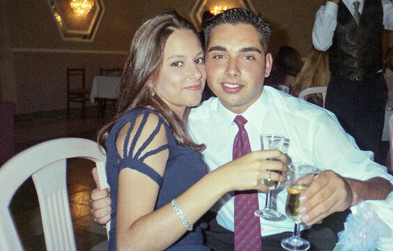 analog film image of teenage couple sitting in a restaurant