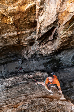 Rock climber in orange color tones