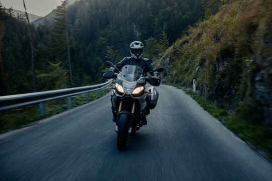 Biker with  sport tour motorcycle on road.
