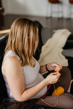 Pregnant woman knitting