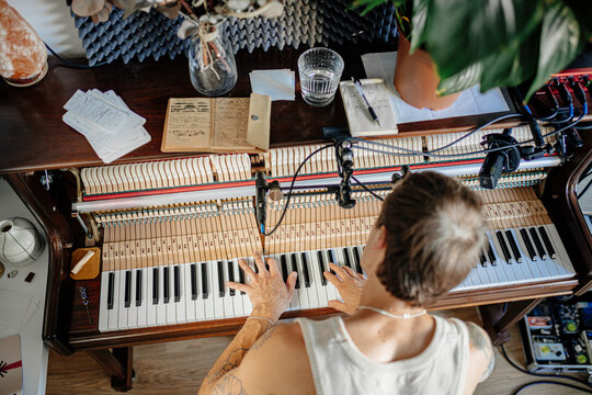 A musician plays the piano at home