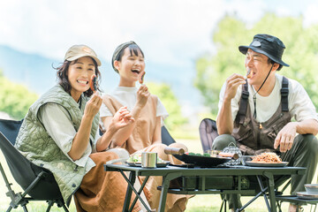 A friendly family enjoying day camping, camping, and barbecues at a park or campsite