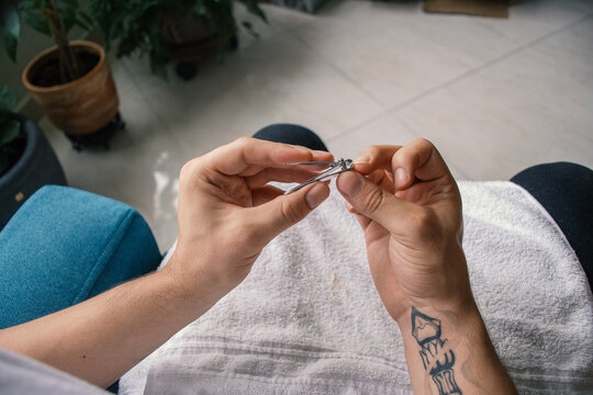 Man Cutting his Nails 