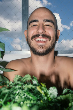 Man Posing in Portraits with Houseplants