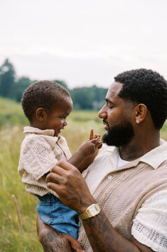 cute moment of black father and son bonding together 