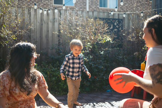 Mothers playing with their child in the backyard