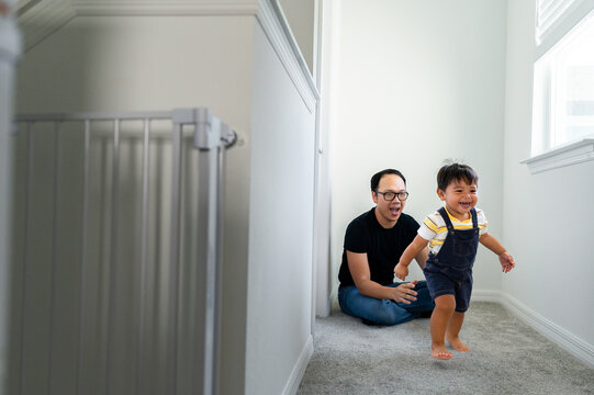 Dad playing with his son in their home