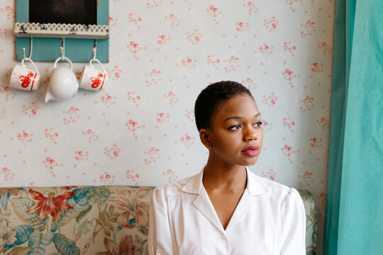 Young Black woman looking to the side indoors
