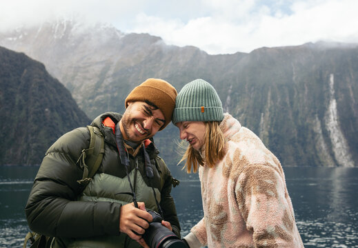 Friends having fun visiting Milford Sound in winter