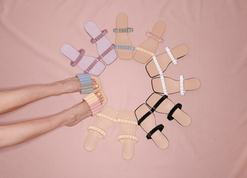 Colorful Sandals Arranged in Circle on Pink Background
