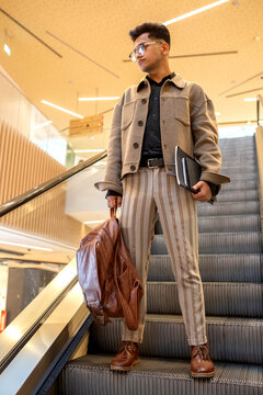 young man with backpack and notebooks