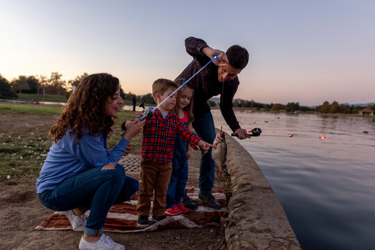 Family Excitedly Reels in a Big Catch During a Sunset Fishing Ad