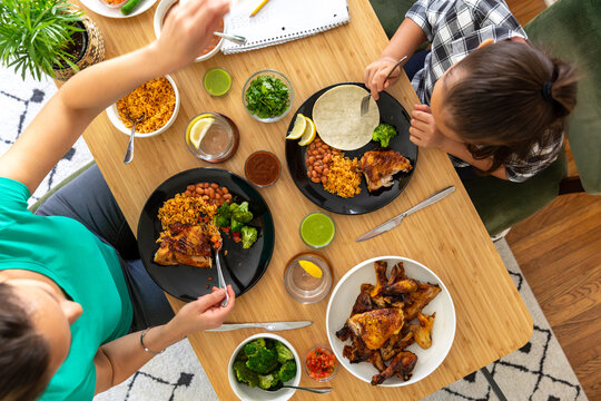 Family Enjoying a Chicken Dinner with Homework
