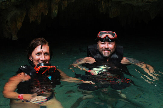 Couple On A Cenote Cave In Mexico