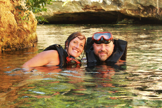 Couple swimming together in cenote
