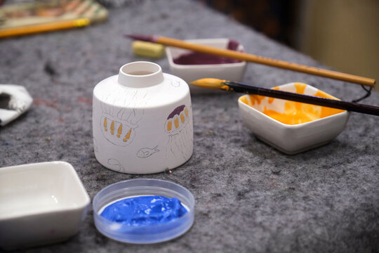 Painted ceramic cups on the studio table
