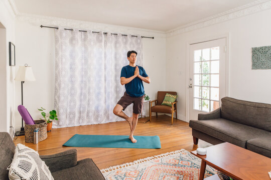 Practicing Tree Pose for Balance and Focus in Home Yoga Session