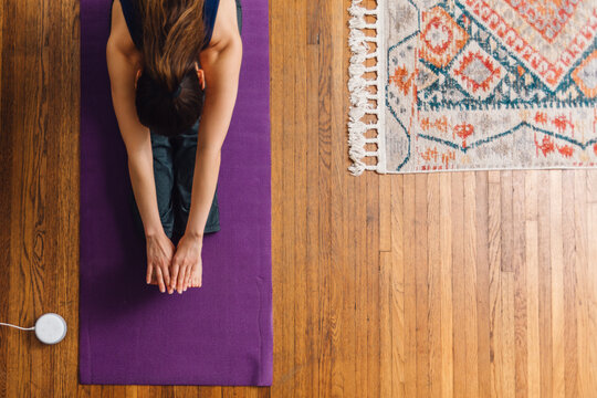 Yoga Forward Fold Stretch on Purple Mat for Flexibility and Calm