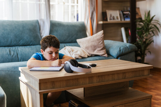 a child doing homework in the living room at home