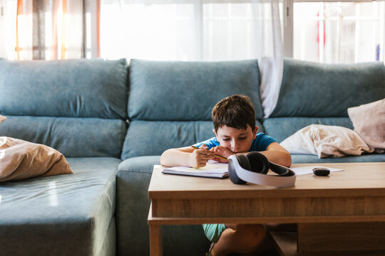 a child doing homework in the living room at home