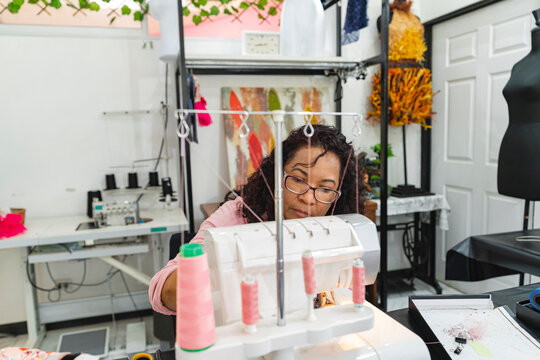 Woman sewing on an overlock machine