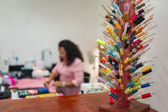 Colorful thread spools in sewing workshop