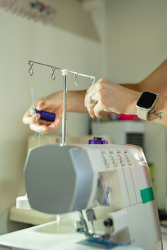Hands adjusting sewing machine