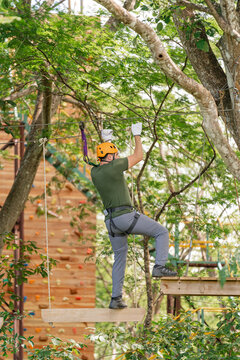 Person crossing a suspension bridge on an adventure course