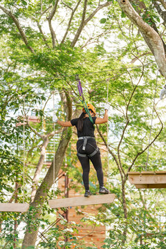Woman on a suspension bridge in an adventure course