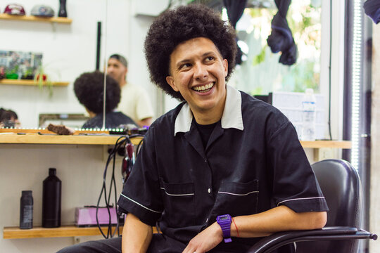 Barber with afro hair smiling portrait