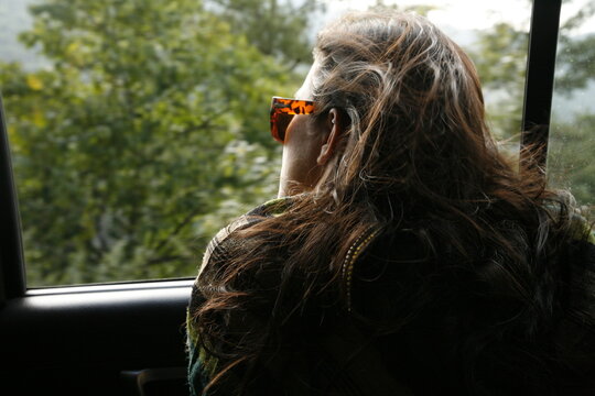 Women looking out car window.