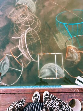 Submerged industrial objects with a view of sneakers on the edge.
