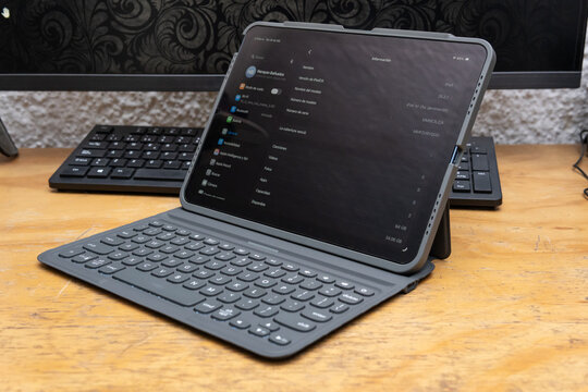 Guadalajara Jalisco, Mexico - February 20, 2025: Ipad Air 5 Tablet with Keyboard on Wooden Desk, tablet concept