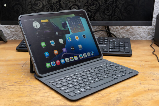 Guadalajara Jalisco, Mexico - February 20, 2025: Ipad Air 5 Tablet with Keyboard on Wooden Desk, tablet concept
