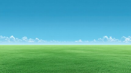 Obraz premium Lush Green Grass Field Under Bright Blue Sky with Soft White Clouds in the Background on a Clear Day