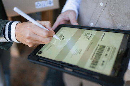 The postman delivers the parcel to the customer