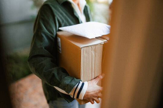 A woman holds parcels in her hands