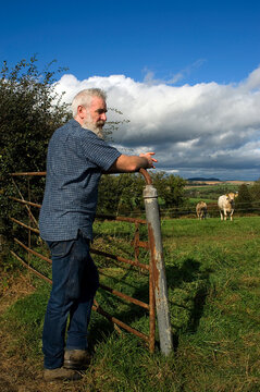 Man leaning on fence