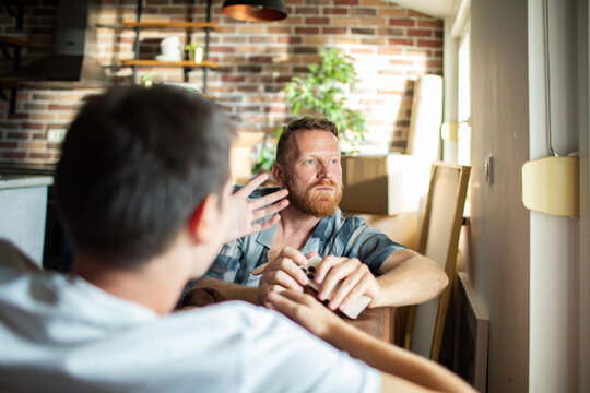 Two men discussing moving plans at home