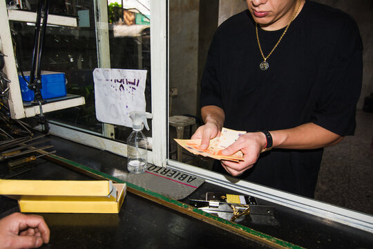 Man paying in cash money for a new lock and keys