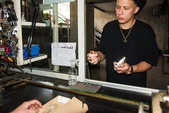 Customer is at the locksmith shop buying a lock and keys