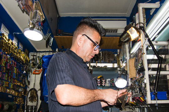 Flash Portrait of locksmith repairing a lock