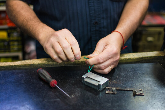 Close up of hands of locksmith doing manual skilled work