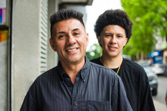 Father and son portrait looking at camera