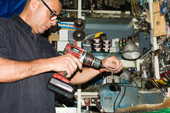 Locksmith fixing a lock in his workshop