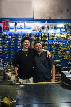 Proud father and son portrait at family shop